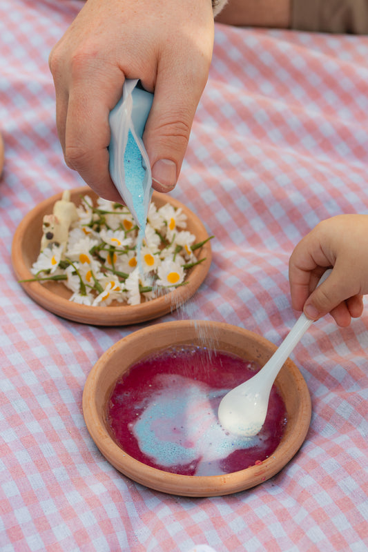 child pouring fizzy potion powder from the unicorn fantasy potion kit