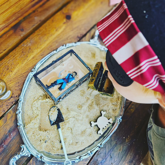 child playing with pirate sand and bubbles