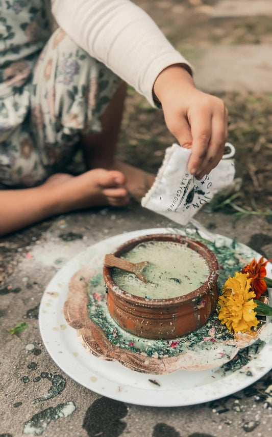 Child playing outside with potion fizz in a bowl