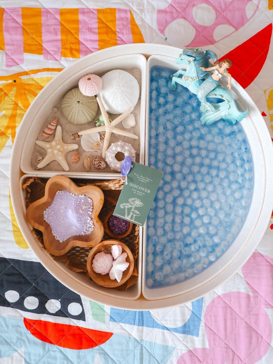 sensory play tray of all the components from the mermaid magic potion kit