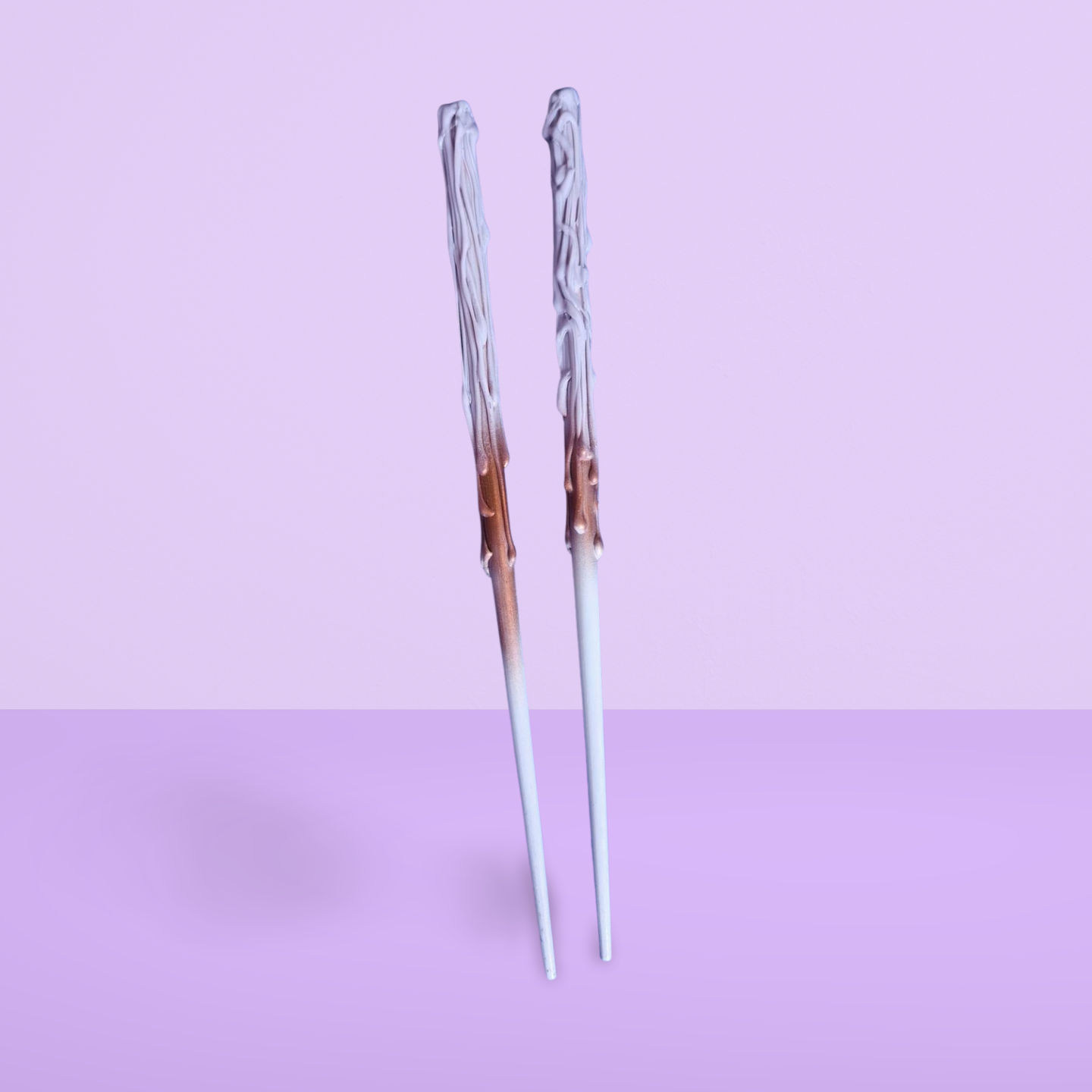 Decorative childs wand with a gradient design on a light purple background