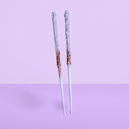 Decorative childs wand with a gradient design on a light purple background