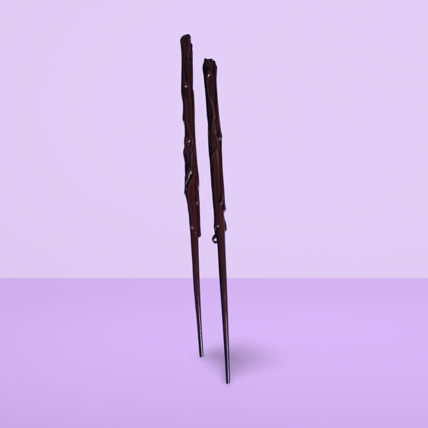 Brown childs wand on a light purple background