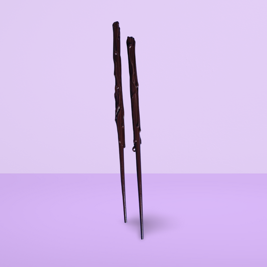 Brown childs wand on a light purple background