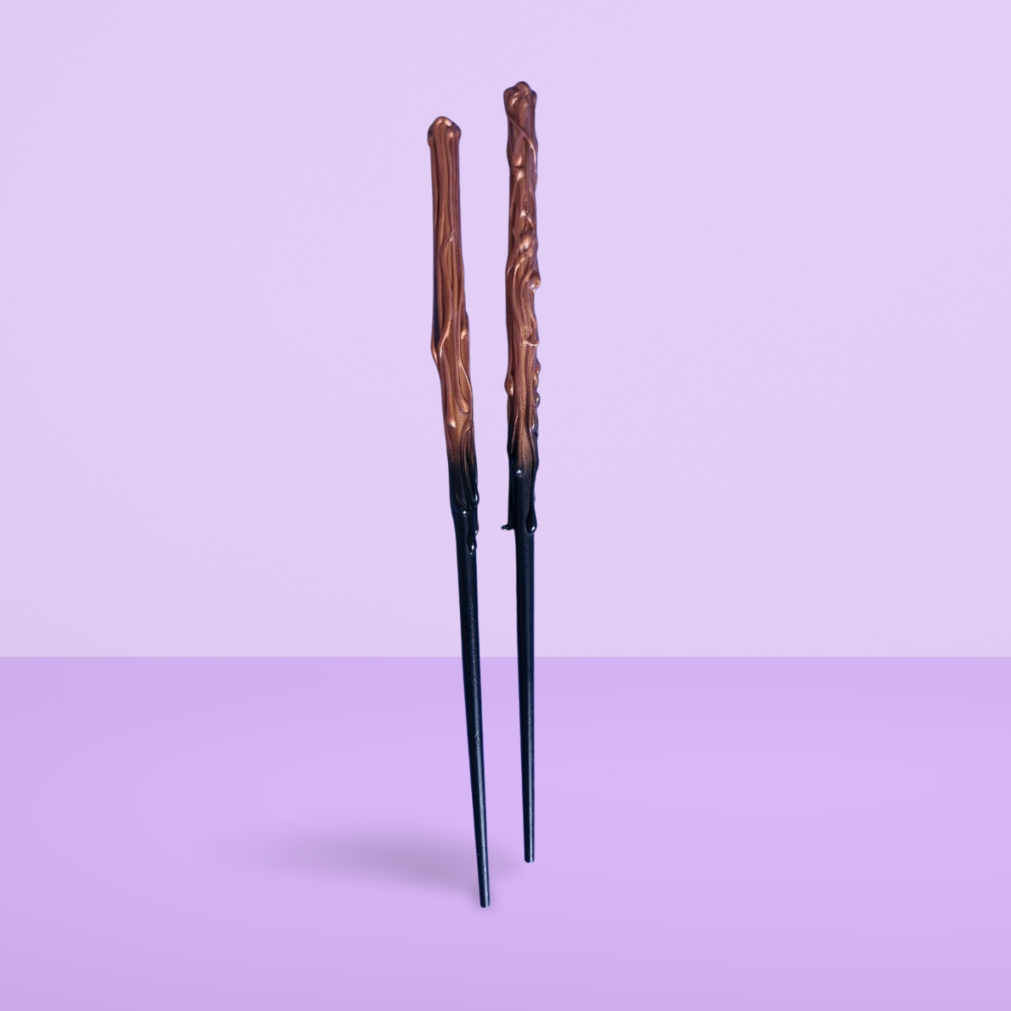 Magical gold and black childs wand on a light purple background