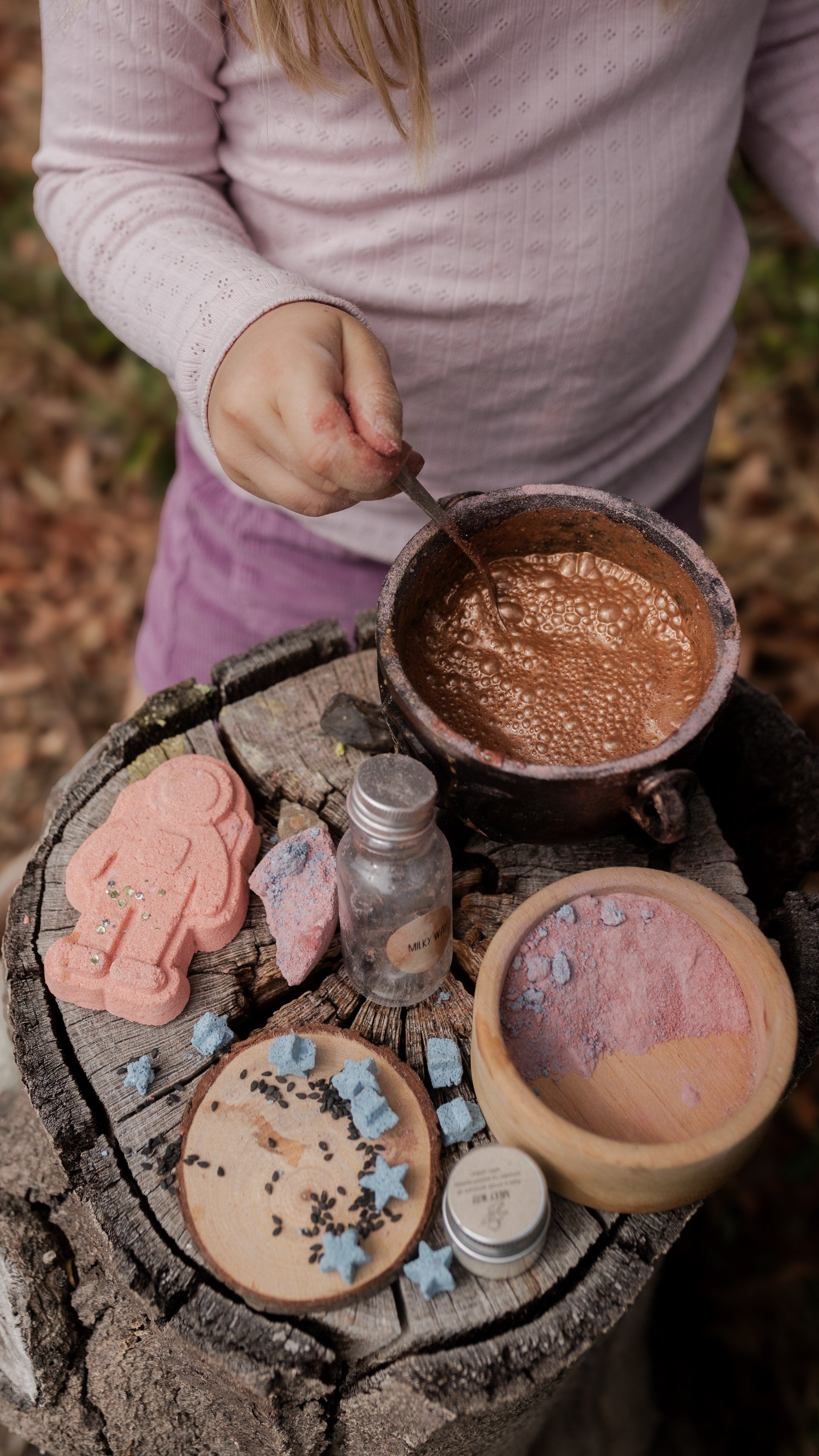 child playing stirring potions with sensory play